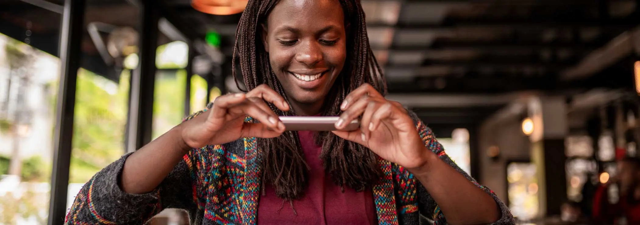 Women takes a picture of something on a table using a smartphone