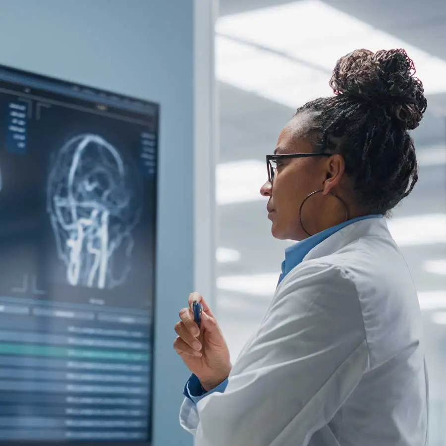 Symbol of development in medical devices: a woman looks at MRI images