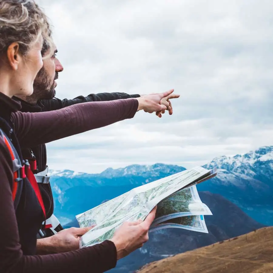 A couple reads the map and points to the distance