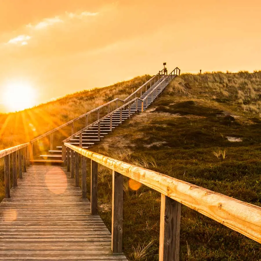 Stairs on the beach with sunset