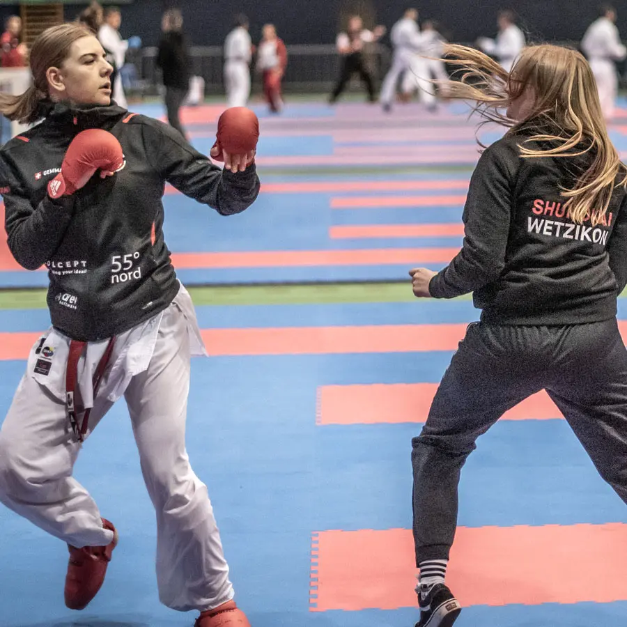 Two karateka warm up for the fight