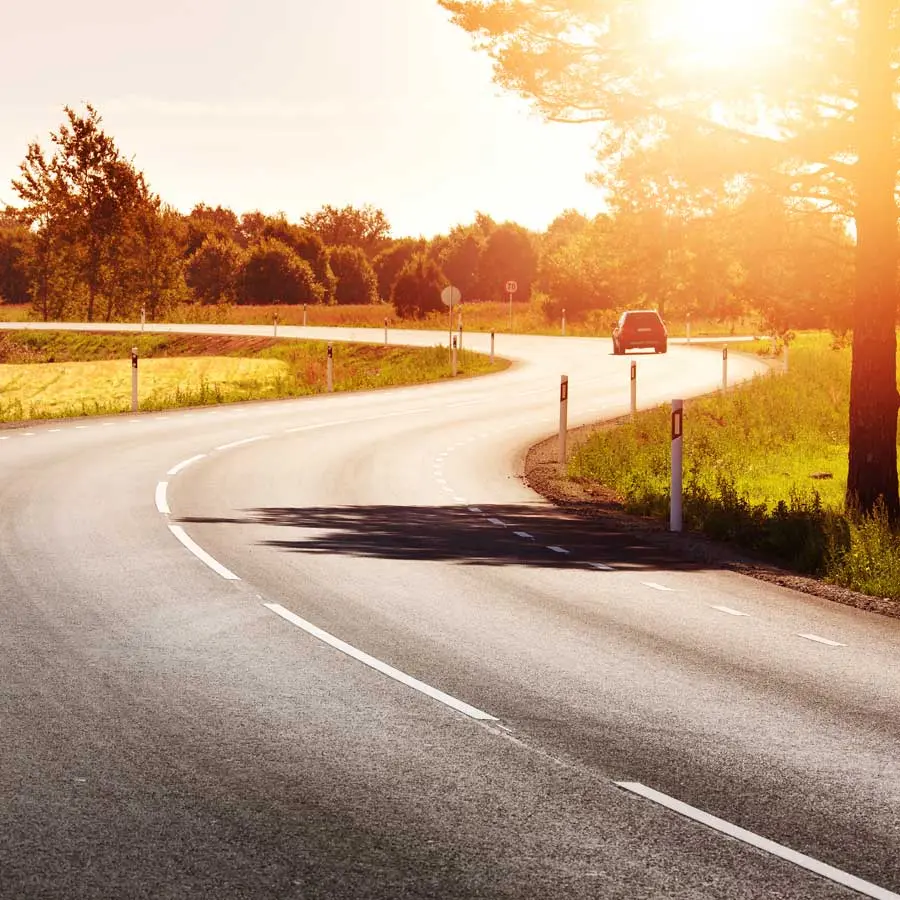 Car on road, sunset