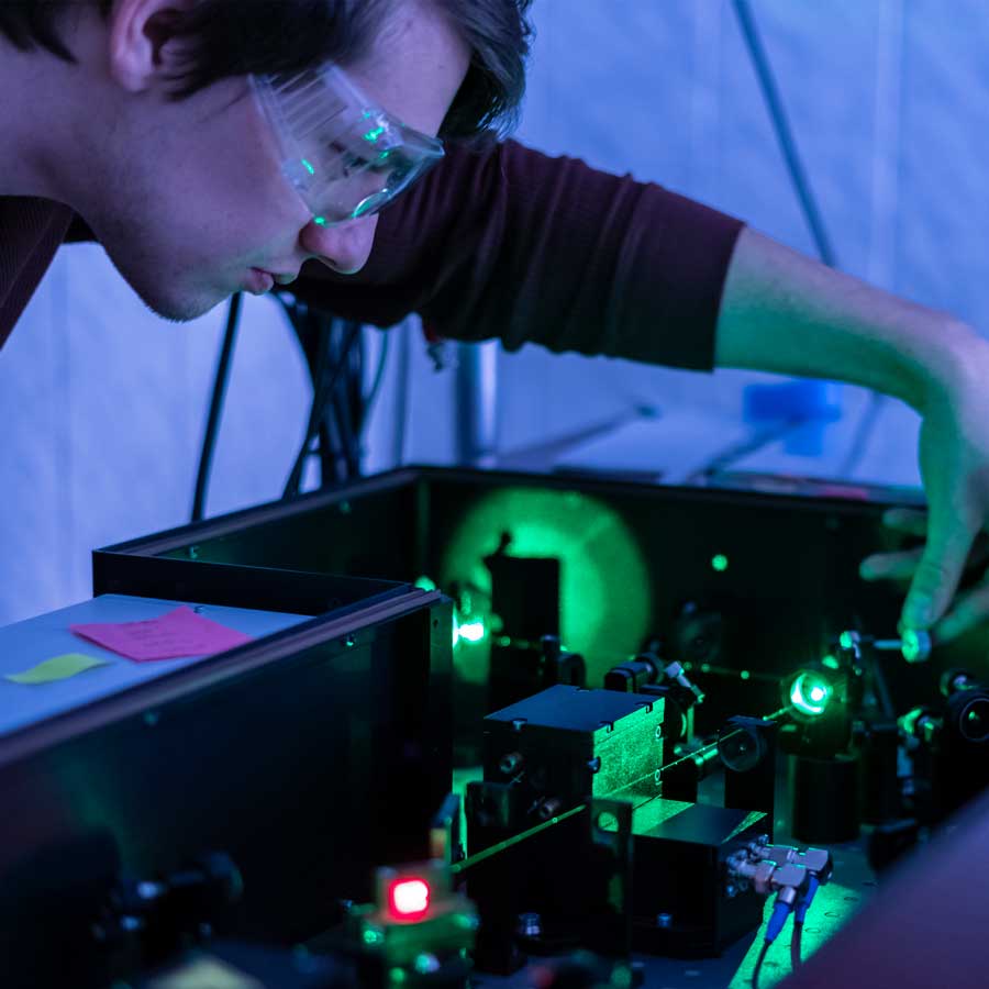 Man adjusts laser