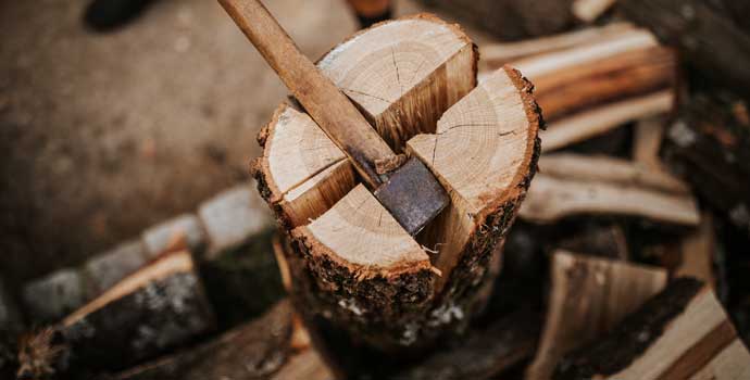 Fire wood is split with an axe