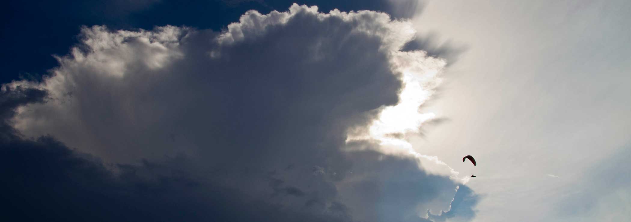 Thunderstorm cloud with paraglider