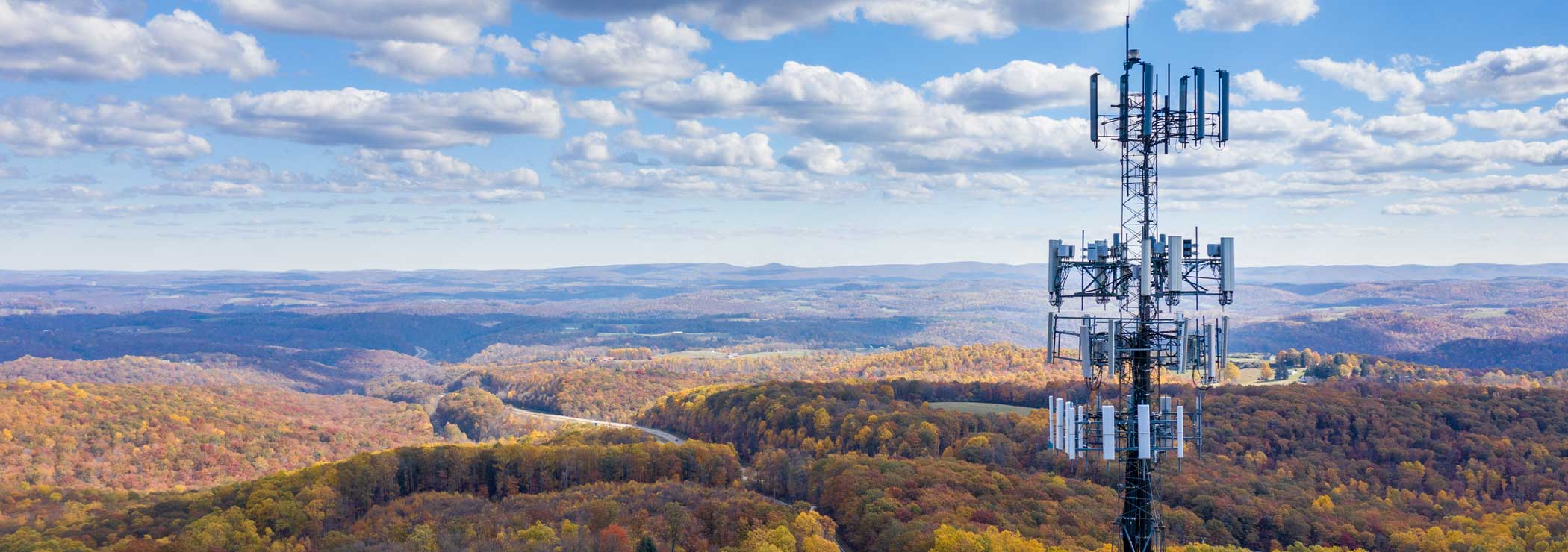 Communication tower with cloudy sky