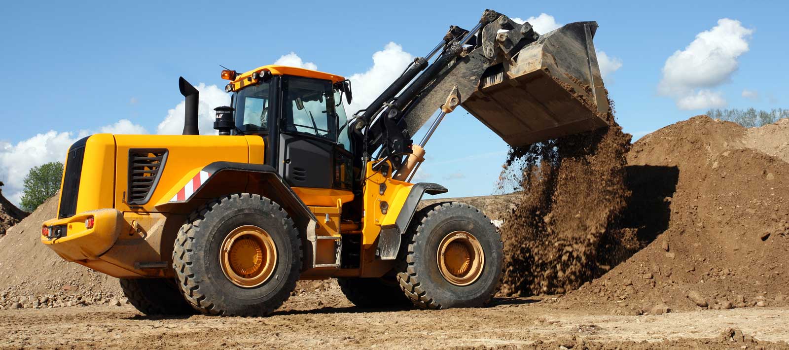 Tired bulldozer heaps up earth