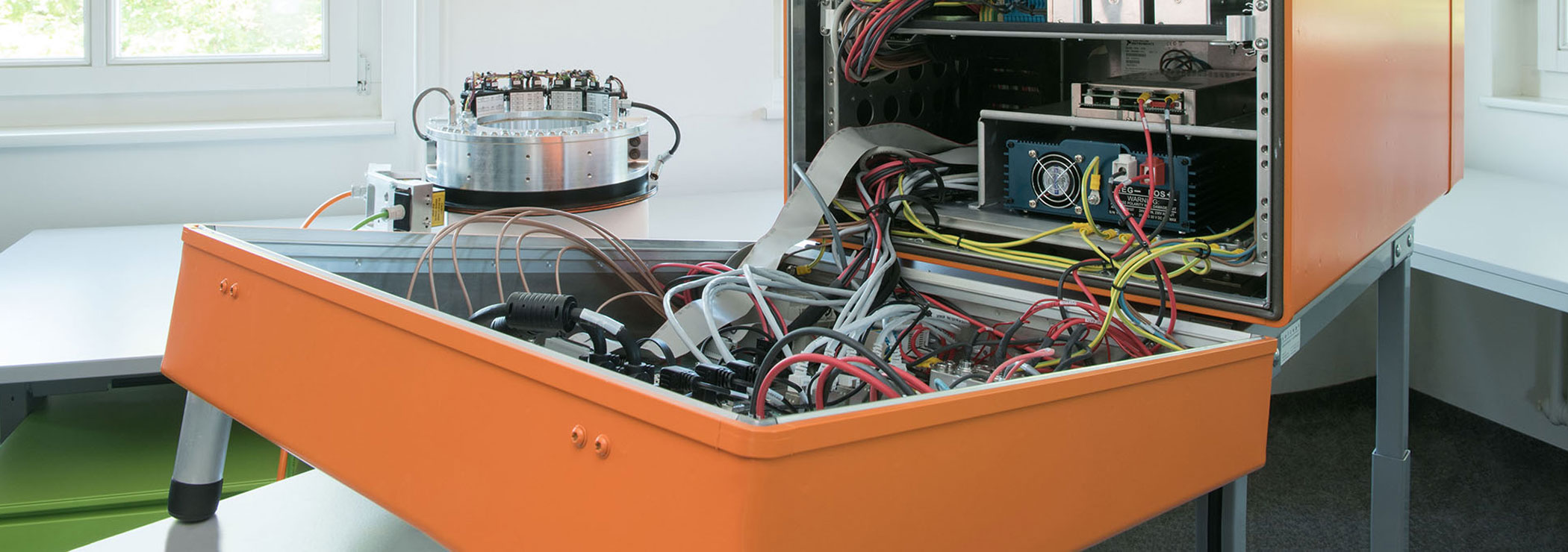 Flight test instrumentation: orange electronics box with measurement and recording devices for flight tests