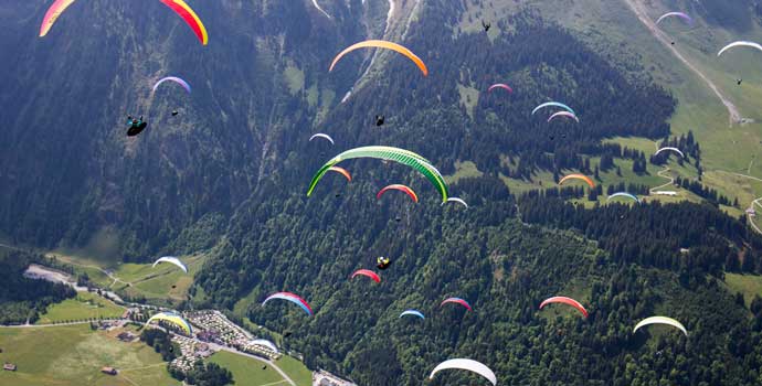 Paragliders flying towards a common goal
